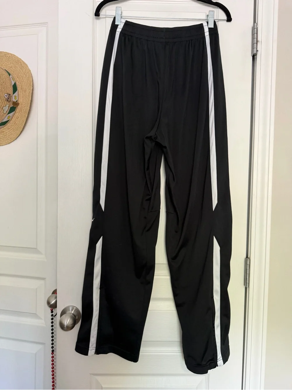 Nike black men’s track pants with white side stripes, size M